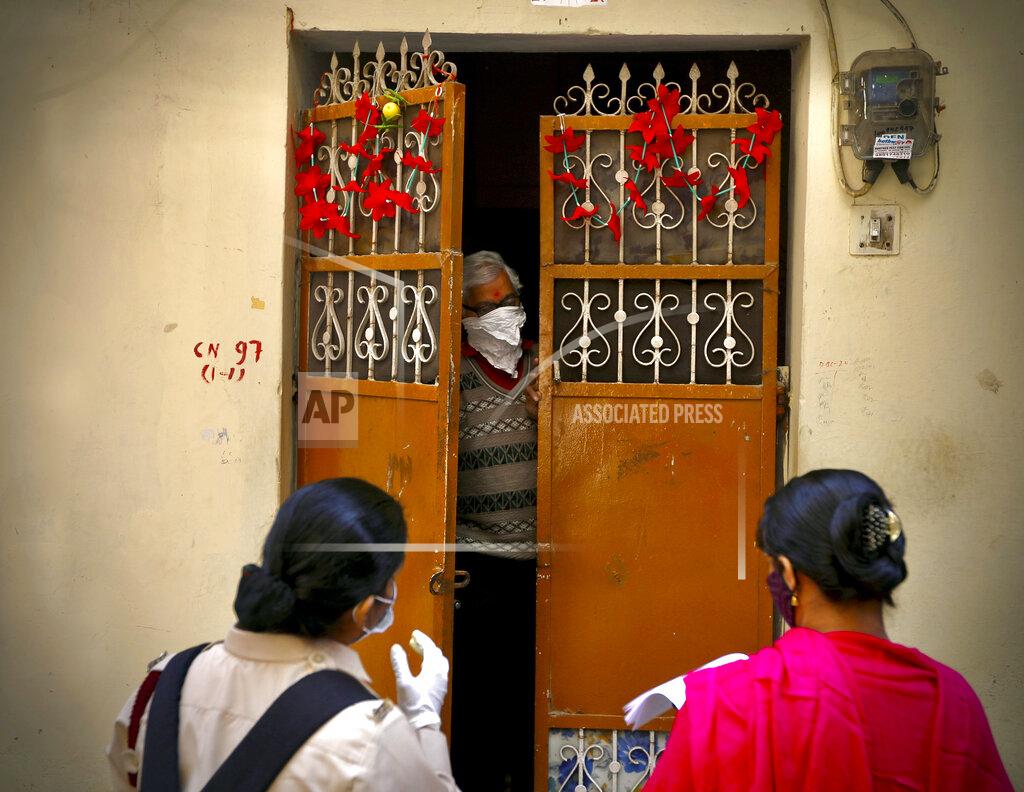 Manish Swarup Health workers conduct a door to door survey to assess the COVID-19 situation in New Delhi, India, Monday, Nov. 23, 2020. India has more than 9 million cases of coronavirus, second behind the United States. (AP Photo/Manish Swarup)