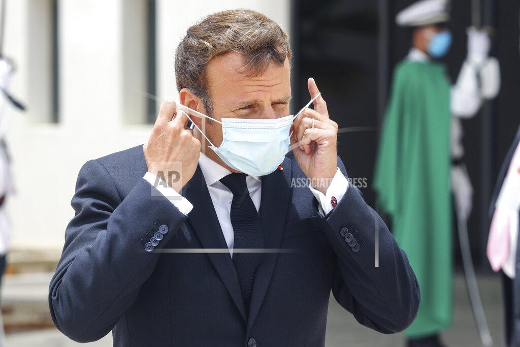 Ludovic Marin French President Emmanuel Macron puts on a face mask upon arrival at Nouakchott Oumtounsy International Airport Tuesday June 30, 2020, in Nouakchott, to attend a G5 Sahel summit. Leaders from the five countries of West Africa's Sahel region, Burkina Faso, Chad, Mali, Mauritania and Niger, meet with French President Emmanuel Macron and Spanish Prime Minister Pedro Sanchez in Mauritania's capital Nouakchott on Tuesday to discuss military operations against Islamic extremists in the region, as jihadist attacks mount. The five African countries, known as the G5, have formed a joint military force that is working with France, which has thousands of troops to battle the extremists in the Sahel, the region south of the Sahara Desert. (Ludovic Marin, Pool via AP)