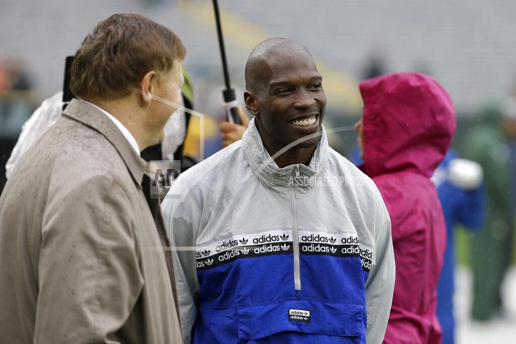 Mike Roemer FILE - In this Sept. 22, 2019, file photo, former NFL football player player Chad Johnson, right, talks with Green Bay Packers president and chief executive officer Mark Murphy before the start of a game between the Denver Broncos and Green Bay Packers in Green Bay, Wis. Chad Johnson left a whooping $1,000 tip for his waiter after dining at a restaurant in Florida that recently reopened amid the coronavirus outbreak. “Congrats on re-opening, sorry about the pandemic, hope this helps. I LOVE YOU,” Johnson wrote Monday, May 18, 2020, on his $37 tab. (AP Photo/Mike Roemer, File)