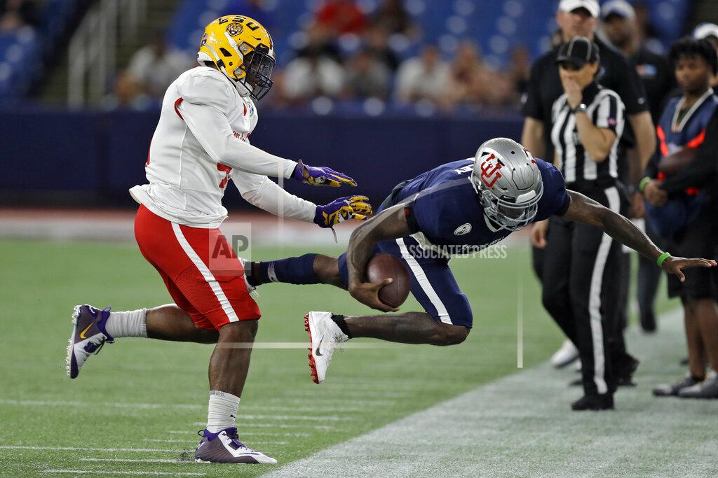 Chris O'meara East linebacker Michael Divinity Jr., of LSU, (45) shoves West quarterback Tyler Huntley, of Utah, (1) out of bounds after a run during the second half of the East West Shrine football game Saturday, Jan. 18, 2020, in St. Petersburg, Fla. (AP Photo/Chris O'Meara)