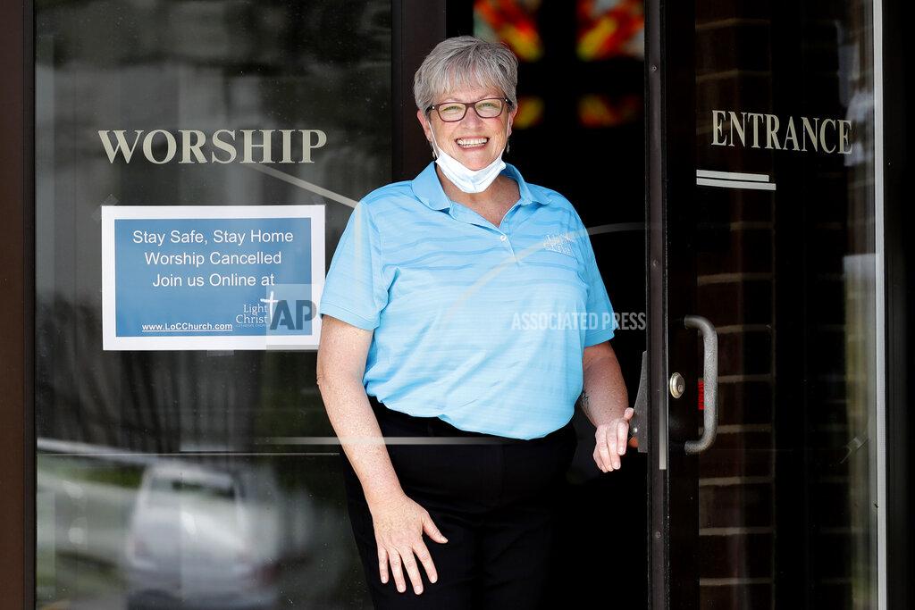 Nam Y. Huh Associate Pastor Sharon Rogers poses for a photo at Light of Christ Lutheran Church in Algonquin, Ill., Sunday, May 24, 2020. “The church is not a building, the church is people,” said Rogers, explaining why parents had embraced the idea of an outdoor service for their children's upcoming confirmation ceremony. (AP Photo/Nam Y. Huh)