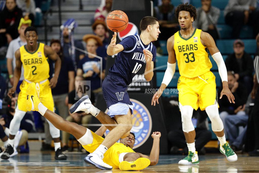 Gerry Broome Baylor guard Mark Vital falls to the floor guarding Villanova forward Cole Swider (10) during the first half of an NCAA college basketball championship game at the Myrtle Beach Invitational in Conway, S.C., Sunday, Nov. 24, 2019. (AP Photo/Gerry Broome)