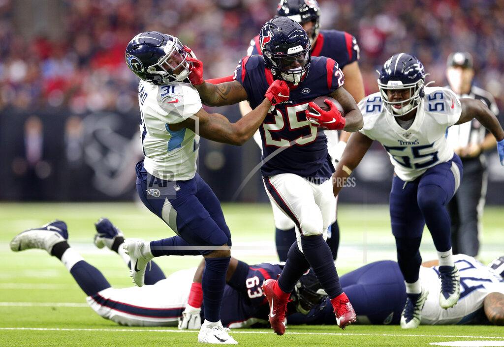 Michael Wyke Houston Texans running back Duke Johnson (25) rushes for a gain as Tennessee Titans free safety Kevin Byard (31) reaches to tackle him during the first half of an NFL football game Sunday, Dec. 29, 2019, in Houston. (AP Photo/Michael Wyke)