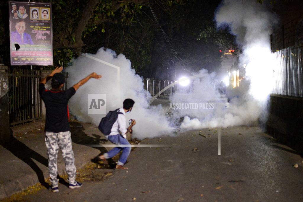 Mahmud Hossain Opu Police use tear gas shells on demonstrators protesting the death in prison of a writer who was arrested on charges of violating the sweeping digital security, in Dhaka, Bangladesh, Friday, Feb. 26, 2021. Mushtaq Ahmed, 53, was arrested in Dhaka in May last year for making comments on social media that criticized the Prime Minister Sheikh Hasina government's handling of the coronavirus pandemic. He had been denied bail at least six times. (AP Photo/Mahmud Hossain Opu)