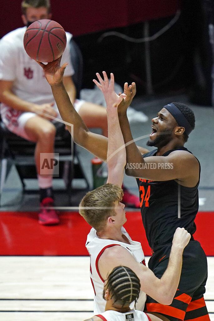 Rick Bowmer Oregon State forward Rodrigue Andela (34) shoots as Utah center Branden Carlson, left, defends during the first half of an NCAA college basketball game Wednesday, March 3, 2021, in Salt Lake City. (AP Photo/Rick Bowmer)