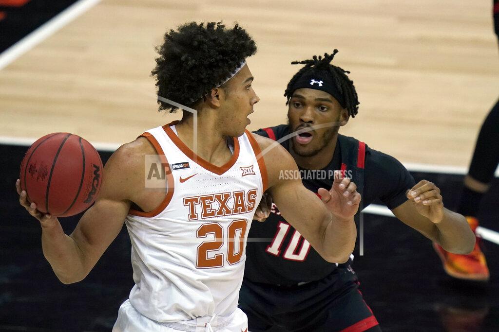 Orlin Wagner Texas forward Jericho Sims (20) looks to pass while covered by Texas Tech Red forward Tyreek Smith (10) during the first half of an NCAA college basketball game in the quarterfinal round of the Big 12 men's tournament in Kansas City, Mo., Thursday, March 11, 2021. (AP Photo/Orlin Wagner)