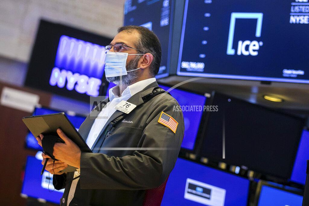 Courtney Crow In this photo provided by the New York Stock Exchange, trader Aman Patel works on the floor of the NYSE, Monday, June 14, 2021. Stocks fell on Wall Street Monday in a sluggish start to the week as investors await the latest take from the Federal Reserve on inflation. (Courtney Crow/New York Stock Exchange via AP)