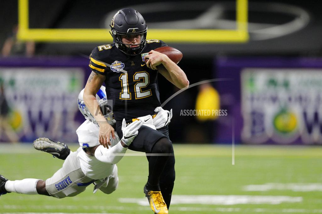 Gerald Herbert Appalachian State quarterback Zac Thomas (12) nearly fumbles the ball as he is tackled by Middle Tennessee safety Gregory Grate Jr. (3) on a carry in the second half of the New Orleans Bowl NCAA college football game in New Orleans, Saturday, Dec. 15, 2018. Appalachian State won 45-13.(AP Photo/Gerald Herbert)
