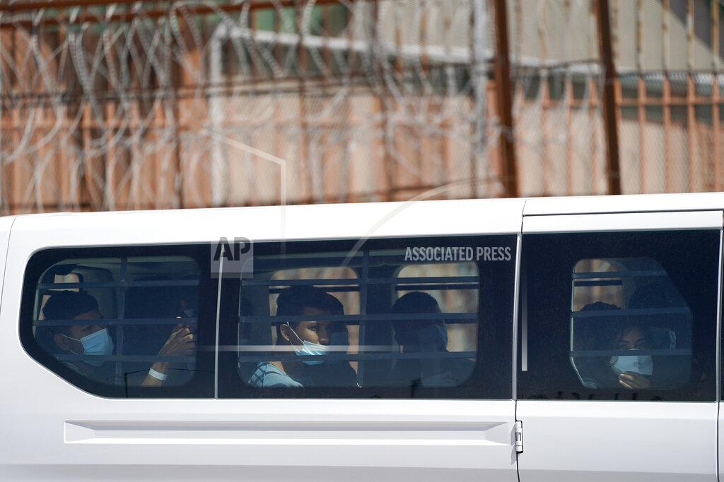Julio Cortez Migrants who were caught trying to sneak into the United States sit in a U.S. Customs and Border Protection van at the McAllen-Hidalgo International Bridge before being deported to Reynosa, Mexico, Thursday, March 18, 2021, in Hidalgo, Texas. A surge of migrants on the Southwest border has the Biden administration on the defensive. The head of Homeland Security acknowledged the severity of the problem Tuesday but insisted it's under control and said he won't revive a Trump-era practice of immediately expelling teens and children. (AP Photo/Julio Cortez)