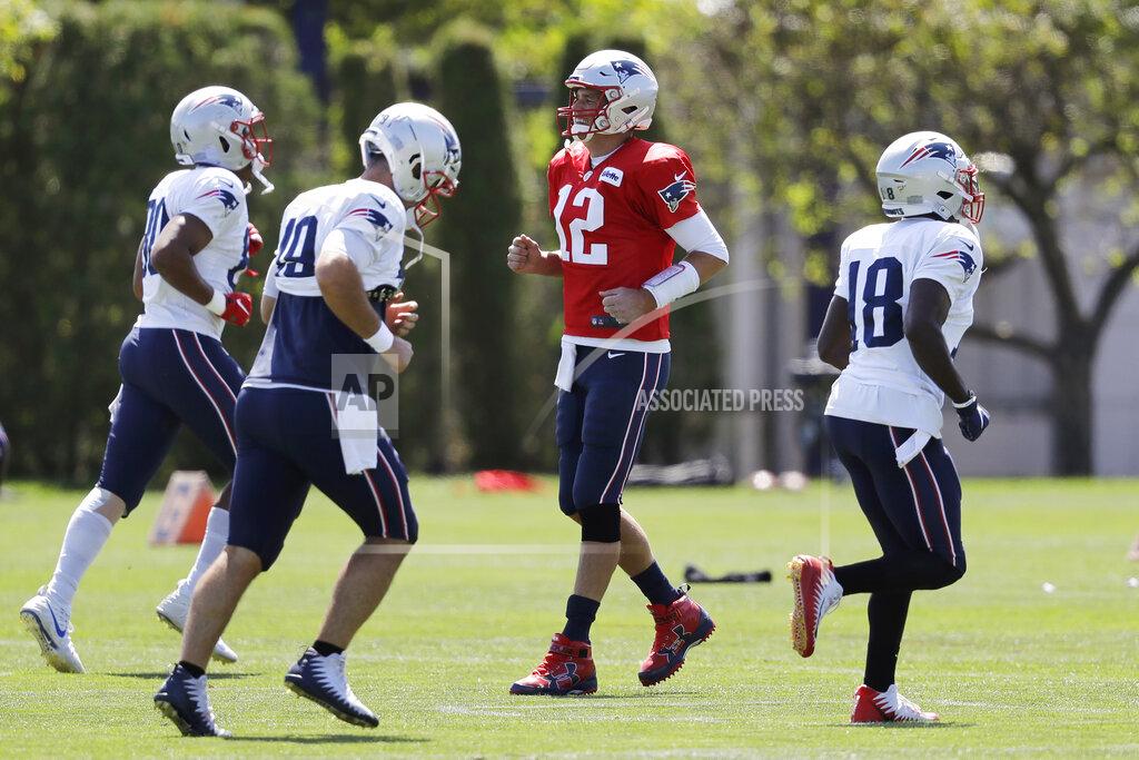 Steven Senne New England Patriots quarterback Tom Brady, center right, smiles while warming up with teammates, from left, tight end Stephen Anderson, long snapper Joe Cardona, and wide receiver Matthew Slater during an NFL football practice, Monday, Aug. 26, 2019, in Foxborough, Mass. (AP Photo/Steven Senne)