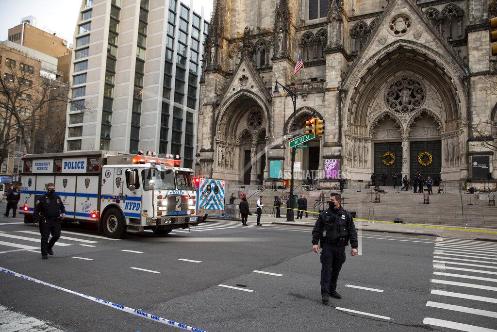 Ted Shaffrey New York police officers block off the scene of a shooting at the Cathedral Church of St. John the Divine, Sunday, Dec. 13, 2020, in New York. A man was shot by police after shots rang out at the end of a Christmas choral concert on the steps of the Manhattan cathedral Sunday afternoon. It's unclear if the gunman was killed or if any others were injured. The shooting happened just before 4 p.m. at the church which is the mother church of the Episcopal Diocese of New York and seat of its bishop. (AP Photo/Ted Shaffrey)