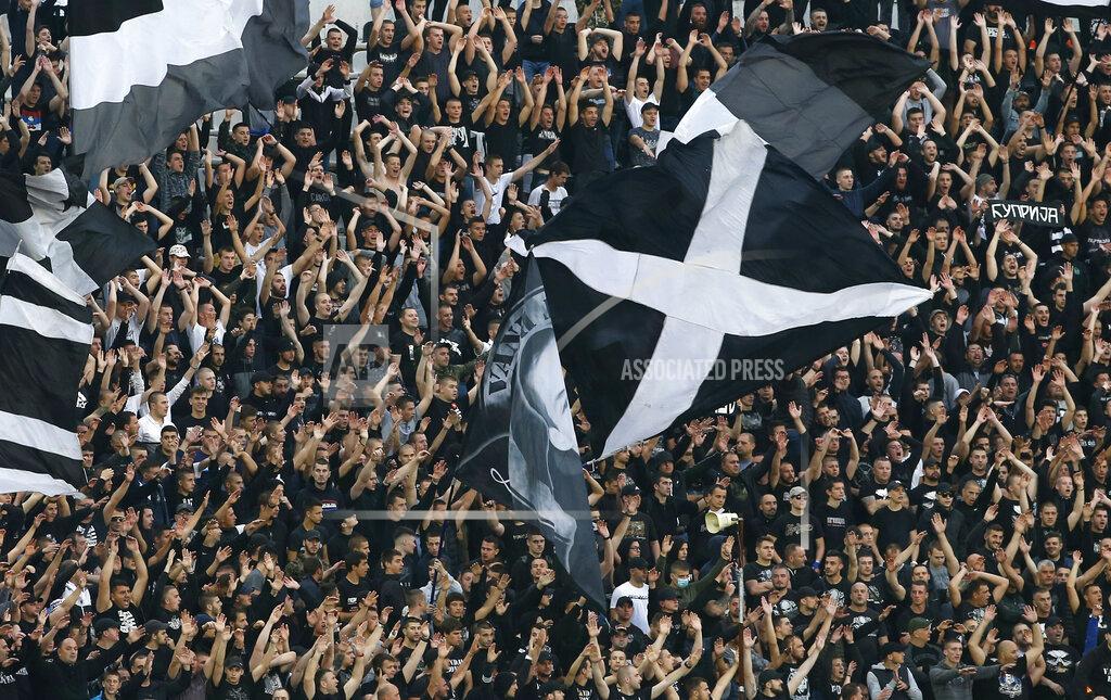 Darko Vojinovic FILE - In this Wednesday, June 10, 2020 file photo, Partizan fans support their team prior a Serbian National Cup semifinal soccer match between Partizan and Red Star in Belgrade, Serbia. Serbia's president Aleksandar Vucic has cancelled his party's pre-election rallies and officials in Bosnia, Macedonia and Albania are appealing on citizens to respect protection measures after relaxation of rules against the new coronavirus led to a recent spike in cases in the Balkan countries. (AP Photo/Darko Vojinovic, File)