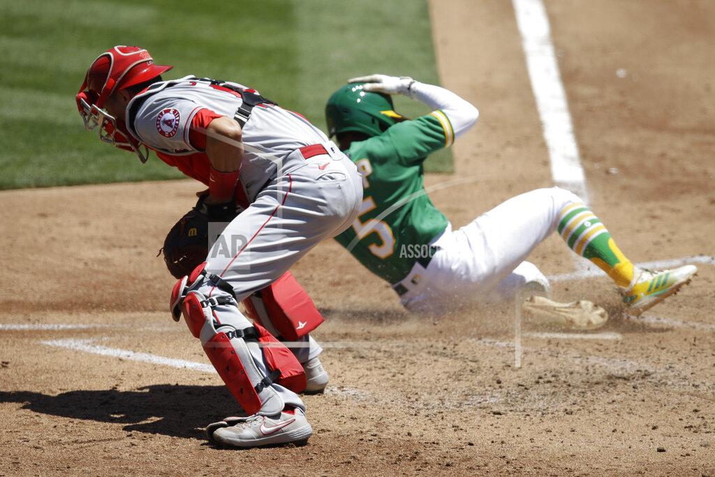 Ben Margot Oakland Athletics' Tony Kemp, right, scores past Los Angeles Angels catcher Jason Castro during the third inning of a baseball game Monday, July 27, 2020, in Oakland, Calif. (AP Photo/Ben Margot)