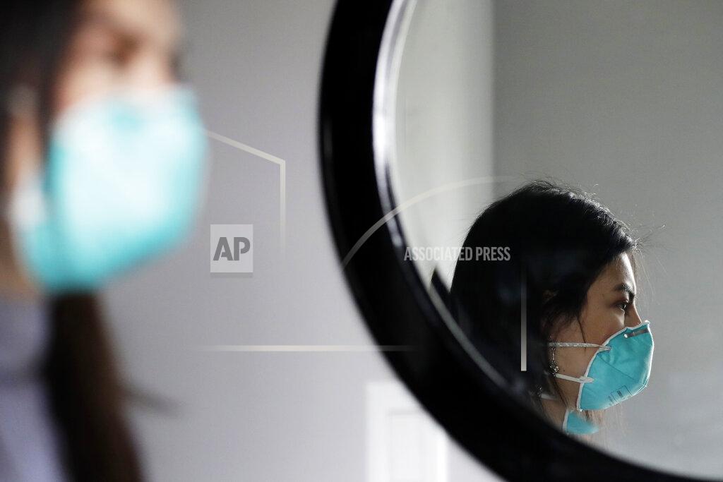 Nam Y. Huh Francy Sandoval poses for a portrait at her home in Melrose Park, Ill., Thursday, April 23, 2020. She works as a receptionist at a community health clinic which treats multiple COVID-19 cases. She has to isolate herself in the attic as soon as she comes home from work each day and is terrified of infecting her family. (AP Photo/Nam Y. Huh)