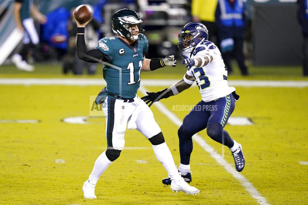 Chris Szagola Philadelphia Eagles' Carson Wentz, left, passes against Seattle Seahawks' Jamal Adams during the first half of an NFL football game, Monday, Nov. 30, 2020, in Philadelphia. (AP Photo/Chris Szagola)