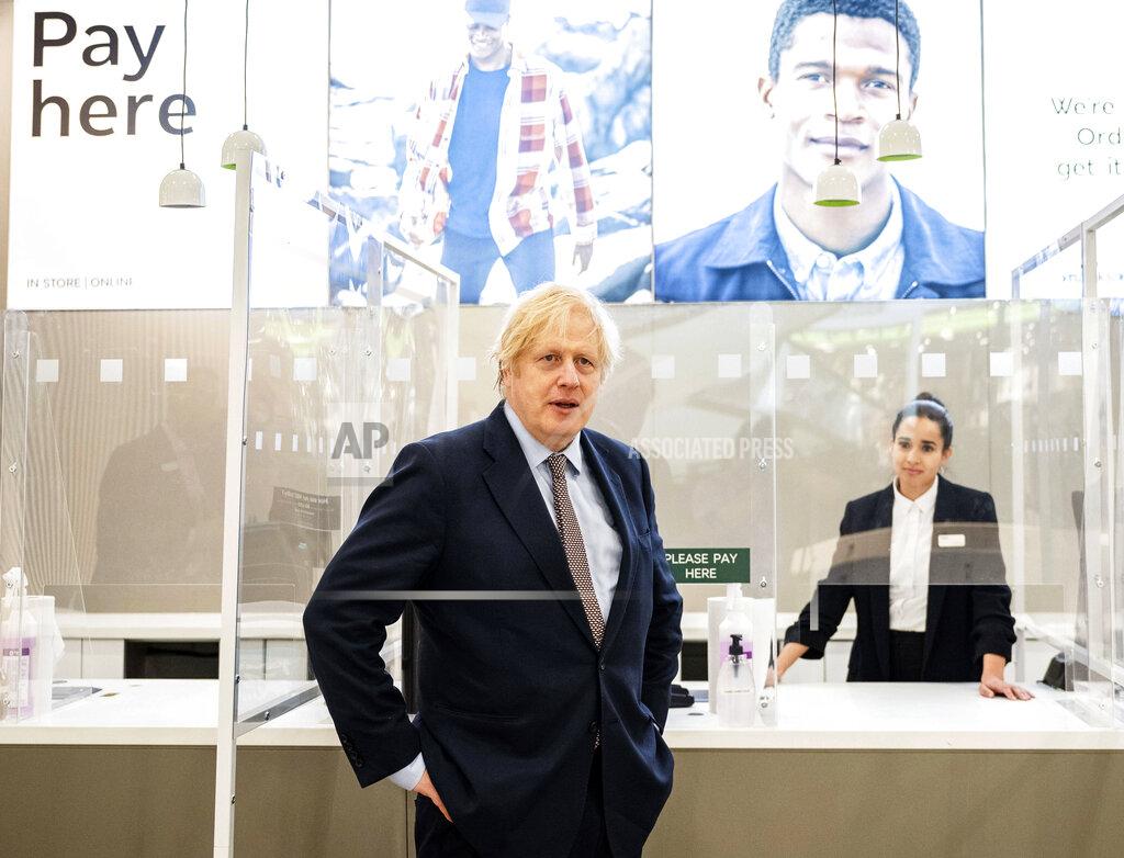 John Nguyen Britain's Prime Minister Boris Johnson visits a shop in Westfield Stratford shopping centre in east London, Sunday June 14, 2020, to see the preparations the stores are making to be COVID-19 secure, ahead of non-essential retail being able to reopen from Monday morning. (John Nguyen/Pool via AP)