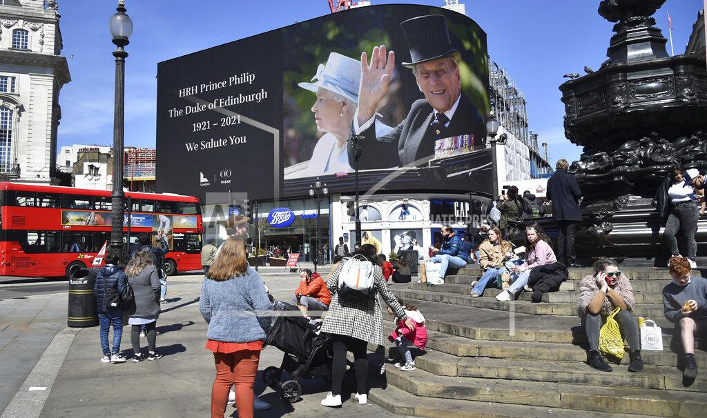 Rui Vieira Images of Britain's Prince Philip are displayed on a giant screen at Piccadilly Circus, London Saturday, April 17, 2021. Prince Philip, husband of Queen Elizabeth II, died Friday April 9 aged 99. His funeral service is taking place at St. George's Chapel inside Windsor Castle Saturday. (AP Photo/Rui Vieira)