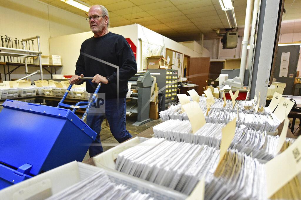 David Dermer Board of Elections worker Bob Moody moves boxes of ballots at the Trumbull County Board of Elections, Tuesday, Nov. 3, 2020, in Warren, Ohio. (AP Photo/David Dermer)