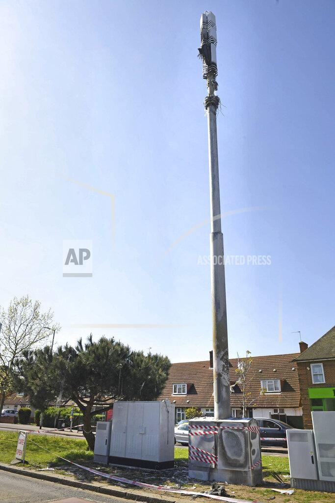 In this Tuesday, April 14, 2020 photo, a view of a cell tower after a fire, in Dagenham, England. Dozens of European cell towers have been destroyed in recent arson attacks that officials and wireless companies say are fueled by groundless conspiracy theories linking new 5G mobile networks and the coronavirus pandemic. (Stefan Rousseau/PA via AP)