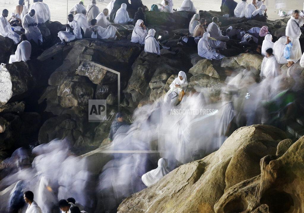 FILE - In this Aug. 10, 2019 file photo taken with low shutter speed, Muslim pilgrims make their way up a rocky hill known as Mountain of Mercy, on the Plain of Arafat, during the annual hajj pilgrimage, ahead of sunrise near the holy city of Mecca, Saudi Arabia. Saudi Arabia says this year’s hajj will not be canceled, but that due to the coronavirus only “very limited numbers” of people will be allowed to perform the major Muslim pilgrimage. The kingdom said Monday, June 22, 2020 that only people of various nationalities already residing in the country would be allowed to perform the hajj. (AP Photo/Amr Nabil, File)