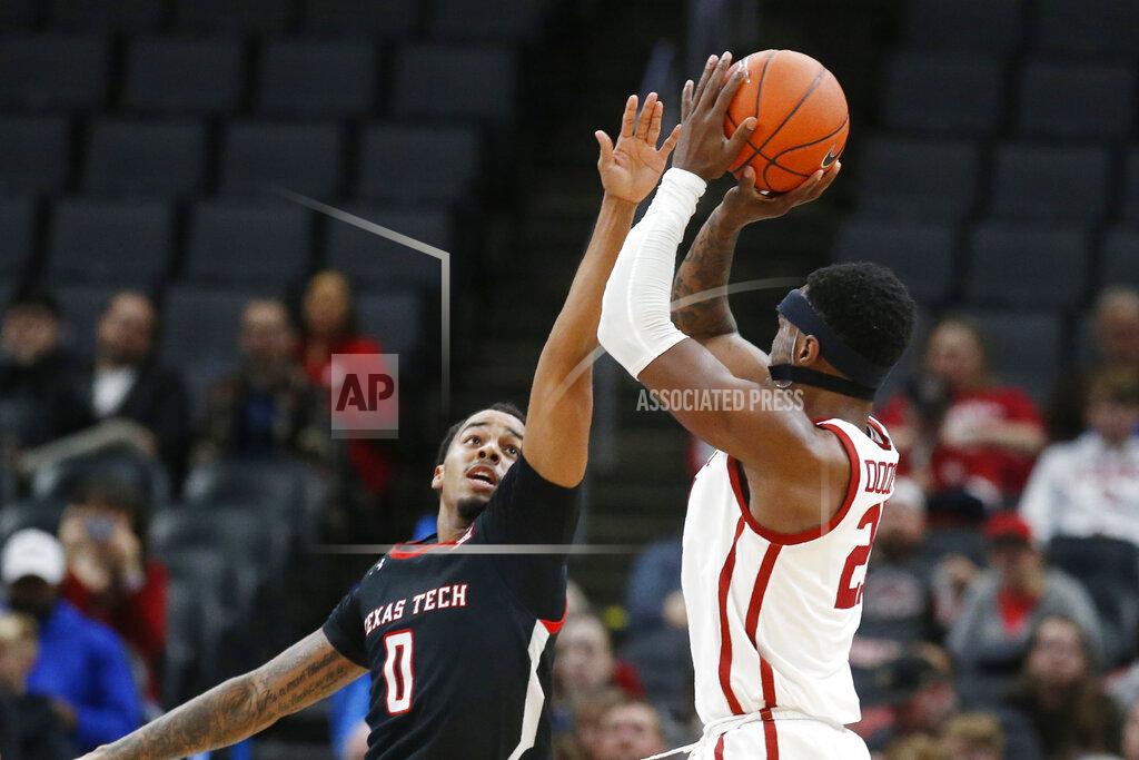 Sue Ogrocki Oklahoma forward Kristian Doolittle, right, shoots over Texas Tech guard Kyler Edwards (0) in the second half of an NCAA college basketball game Tuesday, Feb. 25, 2020, in Oklahoma City. (AP Photo/Sue Ogrocki)
