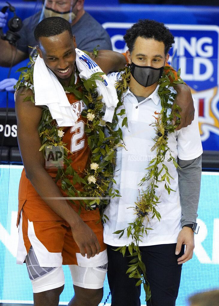 Kathy Kmonicek Texas guard Matt Coleman III (2) hugs head coach Shaka Smart after their team beat North Carolina 69-67 to win the NCAA college basketball game championship for the Maui Invitational, Wednesday, Dec. 2, 2020, in Asheville, N.C. Coleman was the MVP with the winning basket and high score of 22 points.(AP Photo/Kathy Kmonicek)