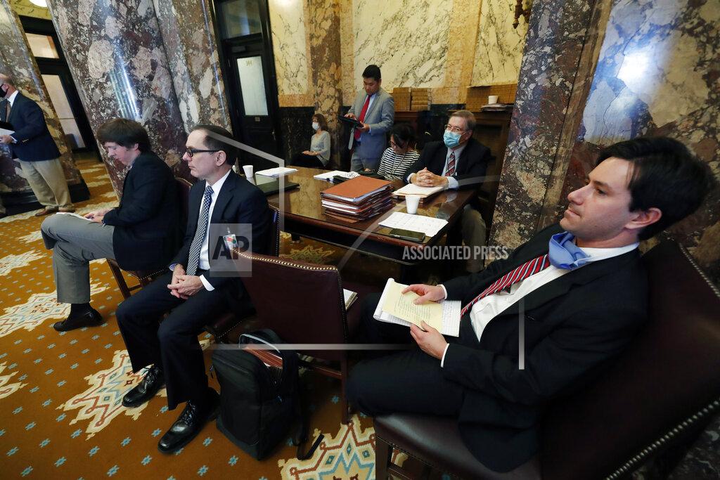 Members of the Legislative Budget Office monitor the presentation of some appropriation and finance bills for debate on the Senate floor at the Capitol in Jackson, Miss., Friday, June 12, 2020. Due to concerns over the coronavirus, lawmakers suspended the Legislative session for several weeks and are now catching up with proposed legislation. (AP Photo/Rogelio V. Solis)