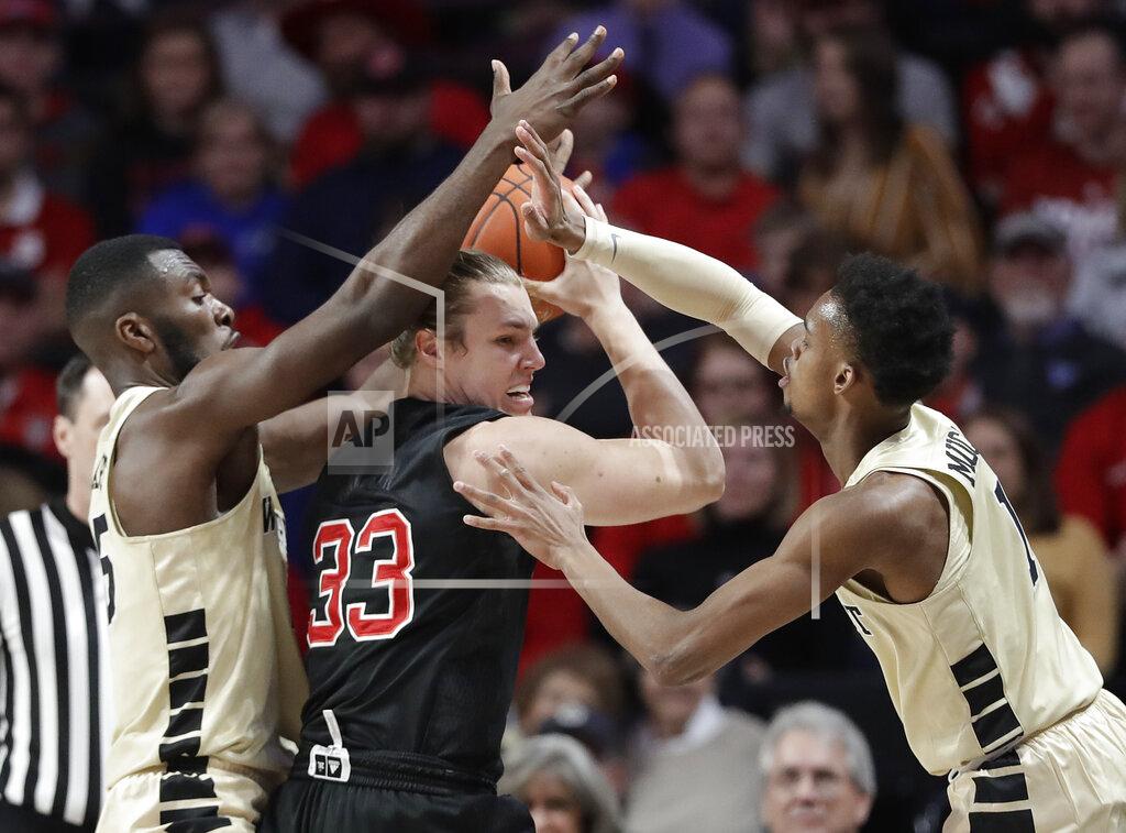 Chuck Burton North Carolina State's Wyatt Walker (33) is trapped by Wake Forest's Isaiah Mucius (1) and Ikenna Smart (35) during the first half of an NCAA college basketball game in Winston-Salem, N.C., Tuesday, Jan. 15, 2019. (AP Photo/Chuck Burton)