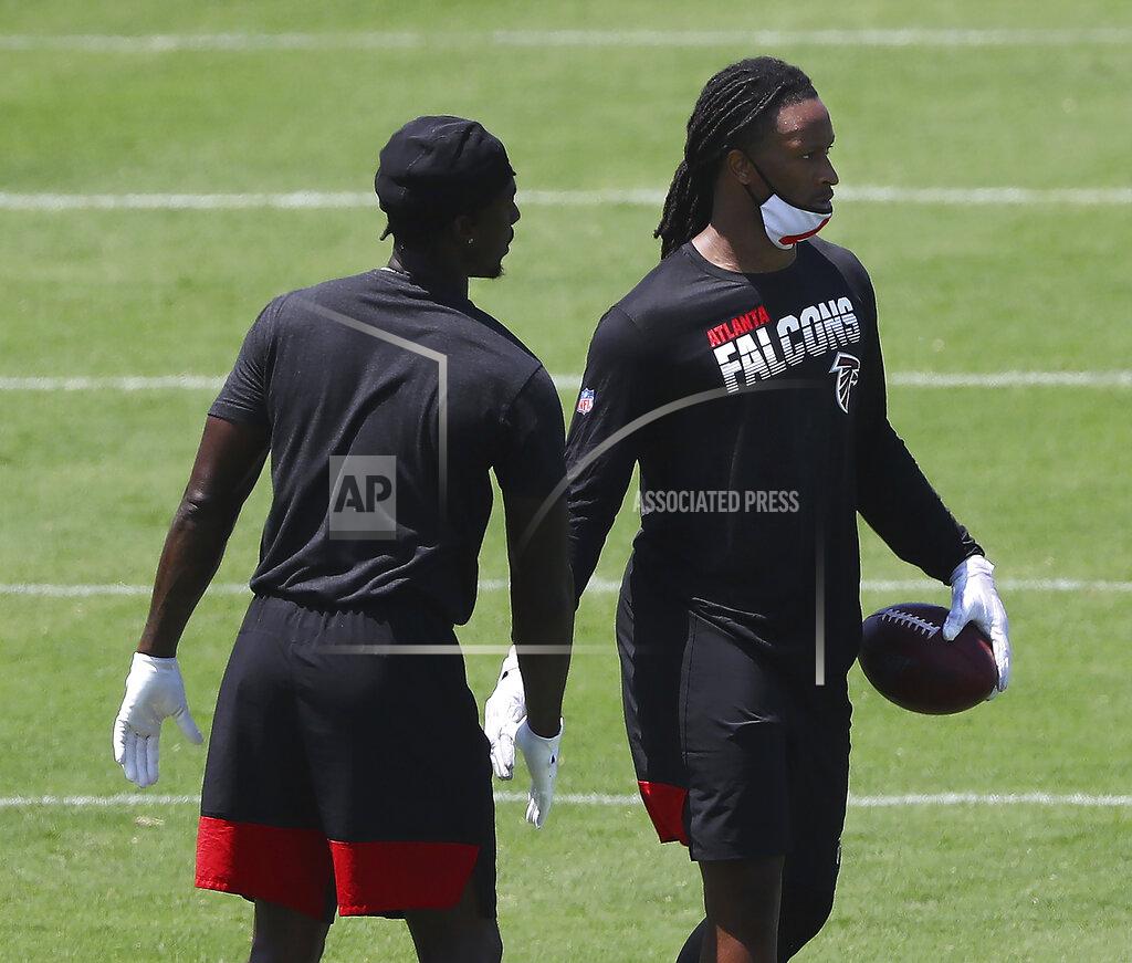 Curtis Compton Atlanta Falcons running back Todd Gurley, right, gets five from wide receiver Calvin Ridley after making a reception from Matt Ryan during a team strength and conditioning NFL football workout, Tuesday, Aug. 4, 2020 in Flowery Branch, Ga. (Curtis Compton/Atlanta Journal-Constitution via AP)