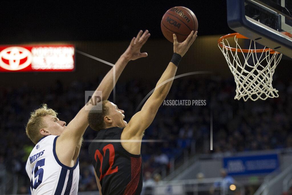 Tom R. Smedes San Diego State guard Malachi Flynn (22) lays the ball up in front Nevada forward Zane Meeks (15) during the first half of an NCAA college basketball game played at Lawlor Events Center in Reno, Nev., Saturday, Feb. 29, 2020. (AP P /Tom R. Smedes)