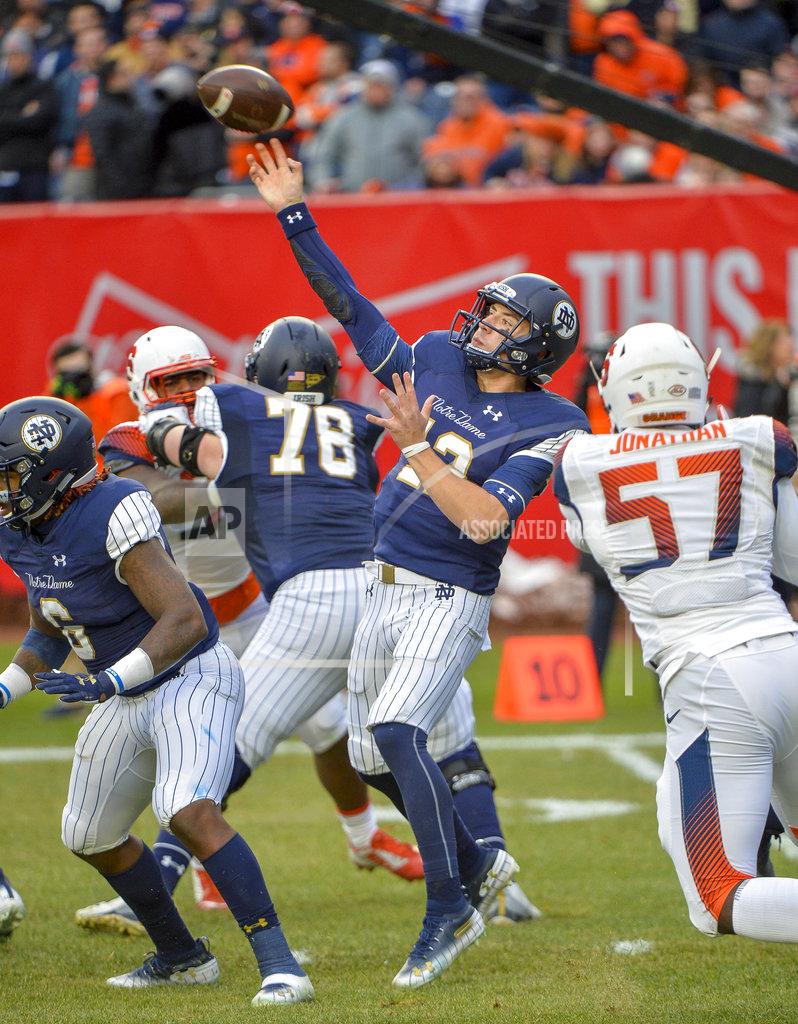 Howard Simmons Notre Dame quarterback Ian Book (12) throws a pass during an NCAA college football game against Syracuse, Saturday, Nov. 17, 2018, at Yankee Stadium in New York. (AP Photo/Howard Simmons)