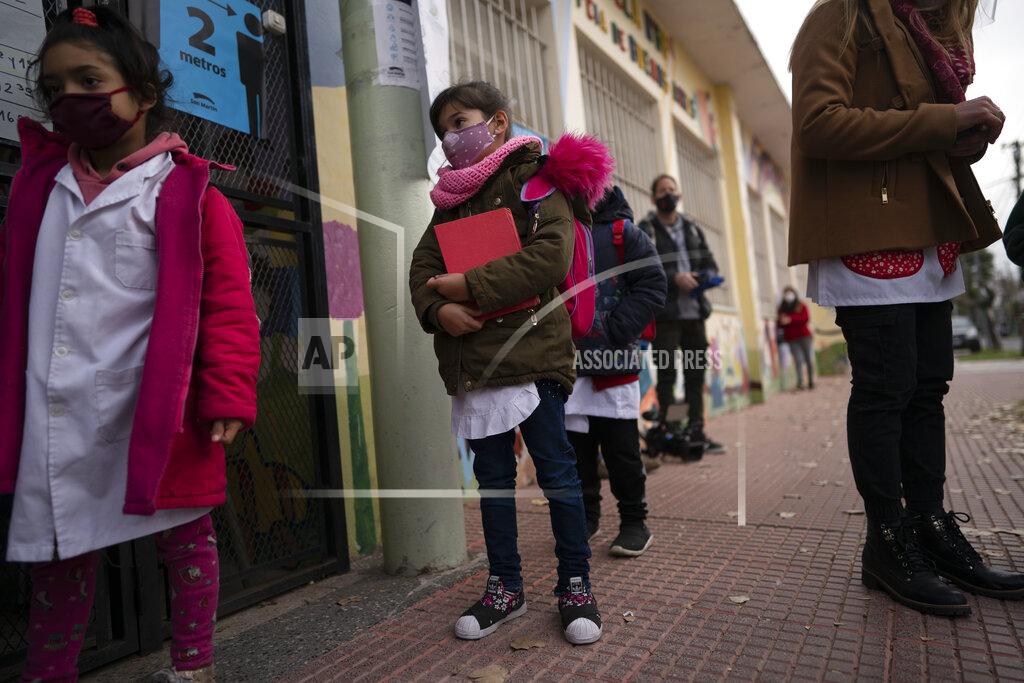 Victor R. Caivano Children stand in line to enter their elementary school in San Martin, a municipality in the Buenos Aires province, Argentina, Wednesday, June 16, 2021. More than 3 million students in the Buenos Aires province resumed in-person classes at all levels Wednesday amid a severe, second wave of the COVID-19 pandemic. (AP Photo/Victor R. Caivano)