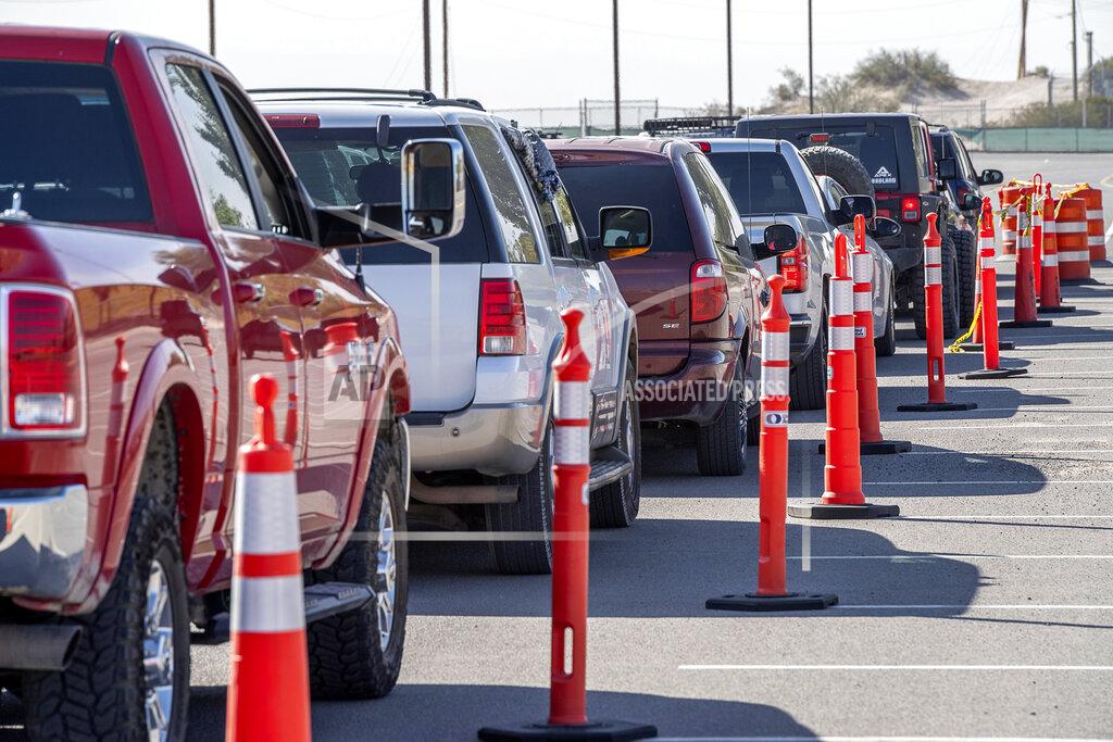 Vehicles are lined up for drive-thru COVID-19 testing in El Paso, Texas, Oct. 14, 2020. Many of those waiting for testing said they waited for over three hours to get tested at the mobile test collection site at the Socorro ISD Student Activities Complex. (Aaron E. Martinez/The El Paso Times via AP)