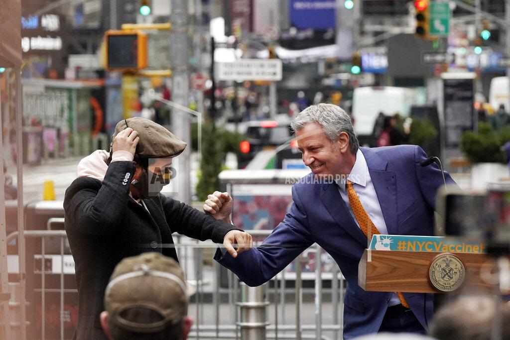 Richard Drew Actor Lin-Manuel Miranda, left, and New York Mayor Bill de Blasio, bump elbows in Times Square after they toured the grand opening of a Broadway COVID-19 vaccination site intended to jump-start the city's entertainment industry, in New York, Monday, April 12, 2021. (AP Photo/Richard Drew)