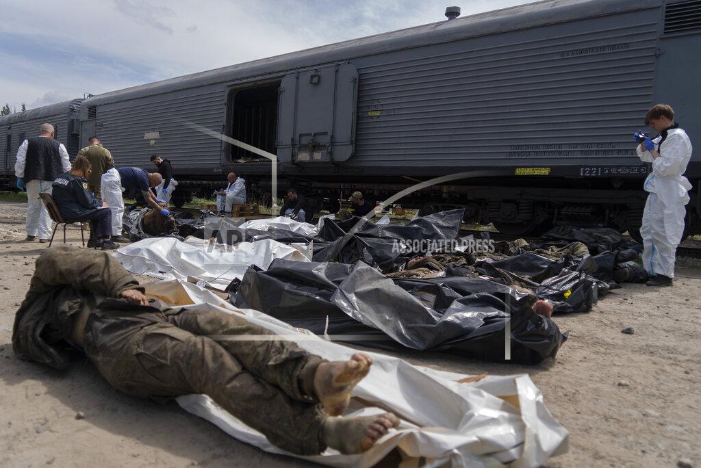 Vasilisa Stepanenko Forensic experts inspect bodies of dead Russian soldiers during an identification process in Kharkiv, east Ukraine, Saturday, May 14, 2022. The bodies of more than 41 Russian soldiers who were found after battles around Kharkiv are being stored in the refrigerated coach. (AP Photo/Vasilisa Stepanenko)