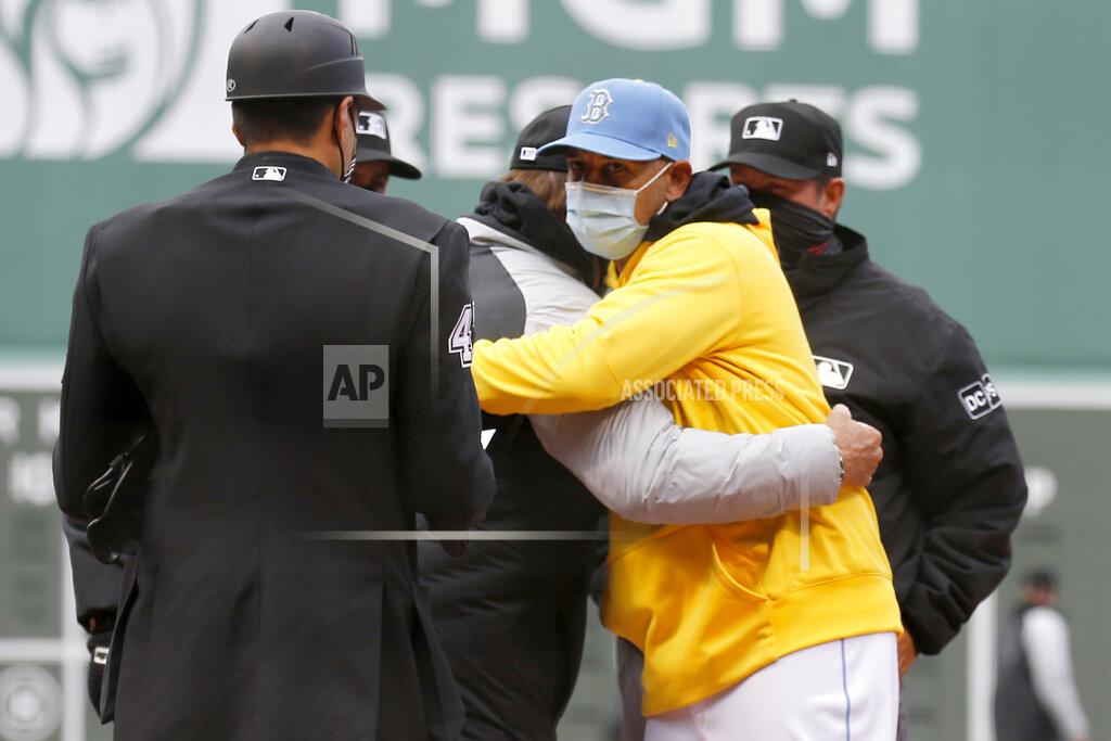 Mary Schwalm Boston Red Sox manager Alex Cora, front right, hugs Chicago White Sox manager Tony La Russa as the exchange lineups before a baseball game, Saturday, April 17, 2021, in Boston. (AP Photo/Mary Schwalm)