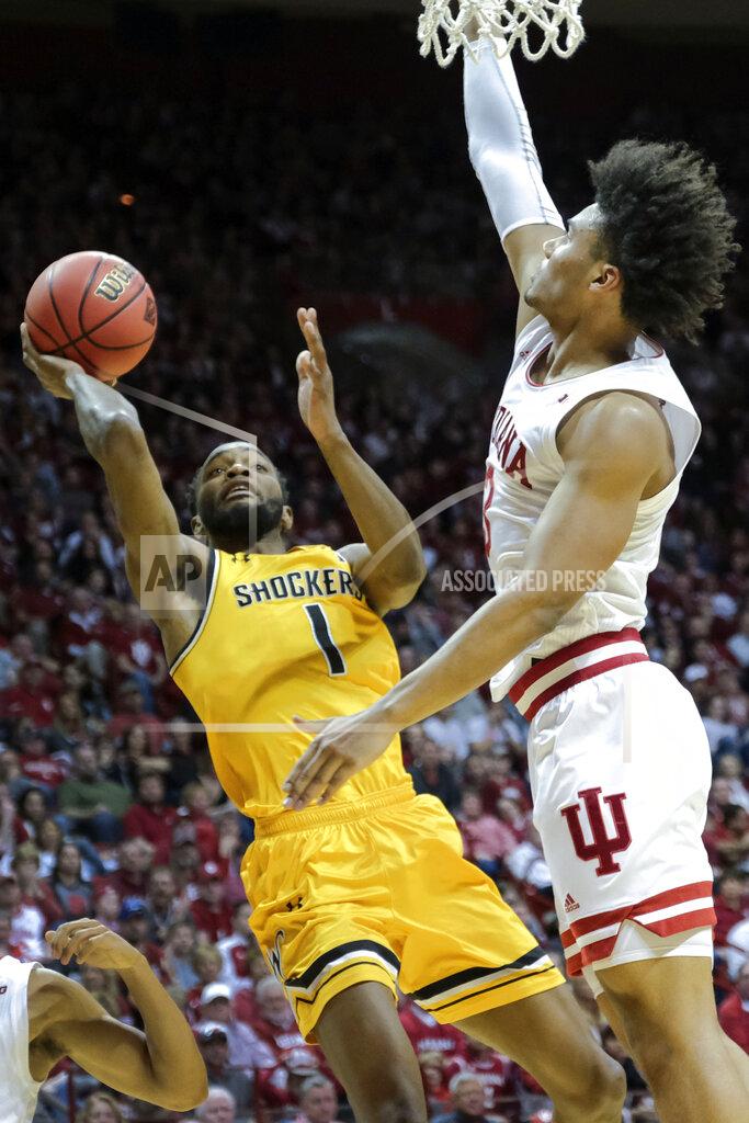 Aj Mast Wichita State forward Markis McDuffie (1) shoots in front of Indiana forward Justin Smith (3) in the first half of an NCAA college basketball game in the third round of the NIT tournament in Bloomington, Ind., Tuesday, March 26, 2019. (AP Photo/AJ Mast)
