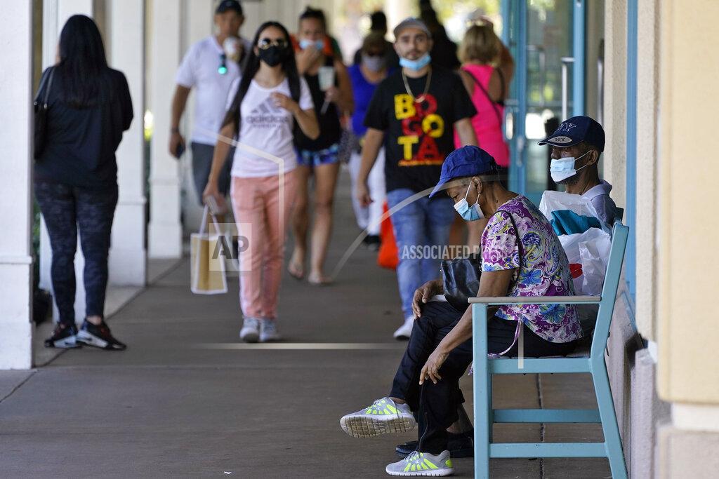 Chris O'meara Shoppers wear protective face masks as they look for Black Friday deals at the Ellenton Premium Outlet stores Friday, Nov. 27, 2020, in Ellenton, Fla. Attendance at the mall was down in an attempt to avoid spreading the corona virus. (AP Photo/Chris O'Meara)