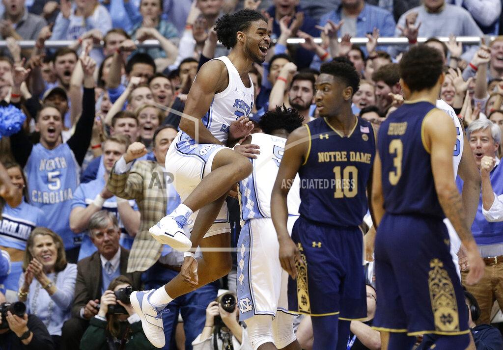 Gerry Broome North Carolina's Coby White jumps while celebrating with Nassir Little while Notre Dame's TJ Gibbs (10) and Prentiss Hubb (3) walk away following a play during the second half of an NCAA college basketball game in Chapel Hill, N.C., Tuesday, Jan. 15, 2019. North Carolina won 75-69. (AP Photo/Gerry Broome)