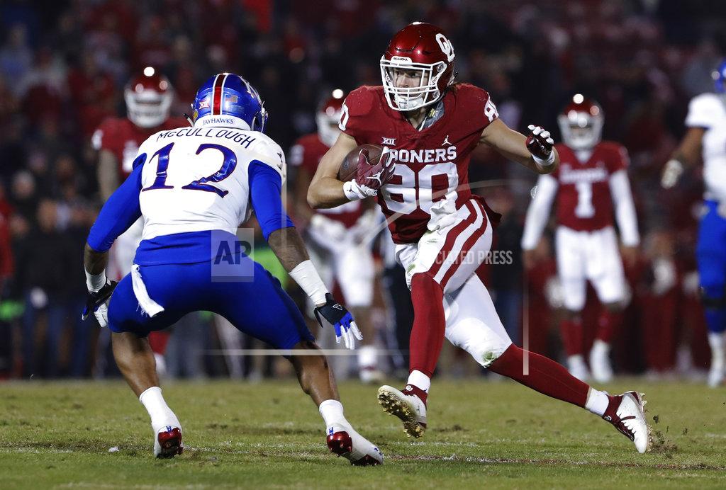 Alonzo Adams Oklahoma tight end Grant Calcaterra (80) runs as Kansas safety Jeremiah McCullough (12) looks to block during the second half of an NCAA college football game in Norman, Okla., Saturday, Nov. 17, 2018. Oklahoma won 55-40. (AP Photo/Alonzo Adams)