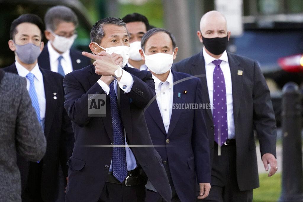Alex Brandon Japanese Prime Minister Yoshihide Suga, second from right, walks Saturday, April 17, 2021, in Washington. (AP Photo/Alex Brandon)