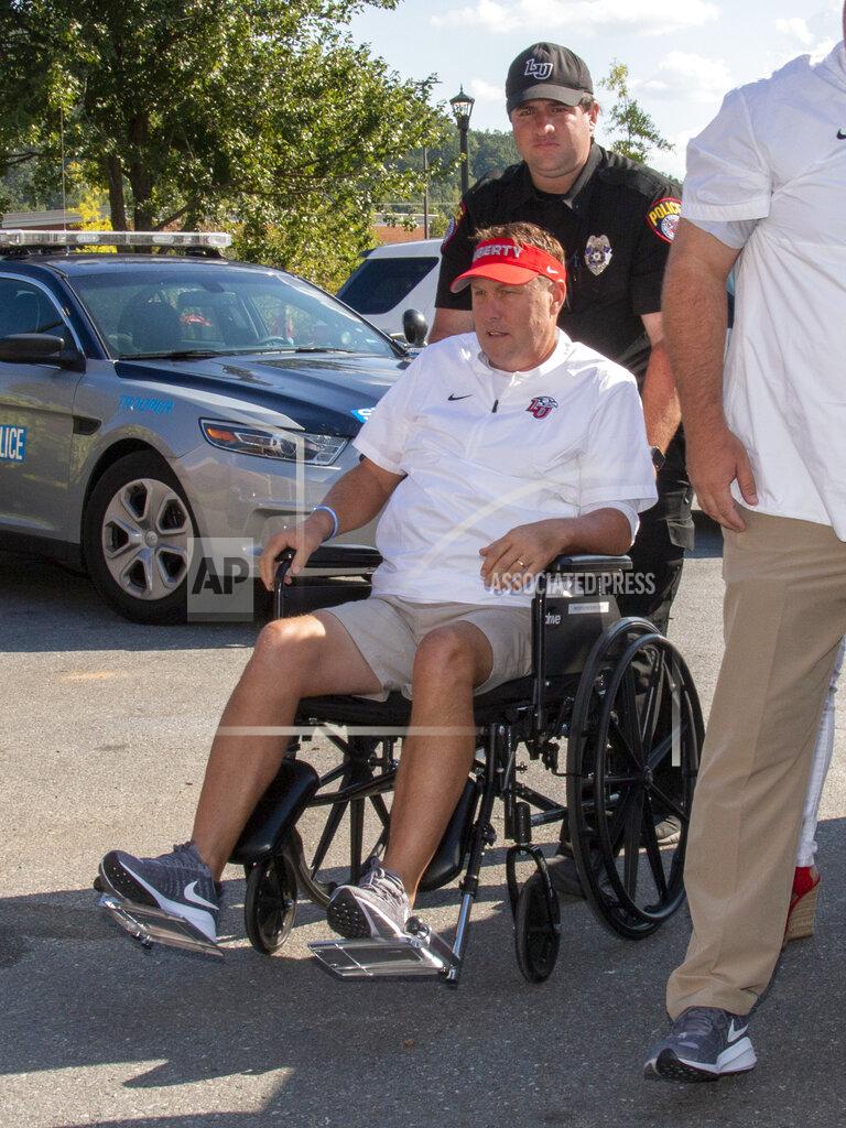Matt Bell Liberty head football coach Hugh Freeze arrives to coach from a wheelchair in the coaches' box against Syracuse in an NCAA college football game in Lynchburg, Va., Saturday, Aug. 31, 2019. (AP Photo/Matt Bell)