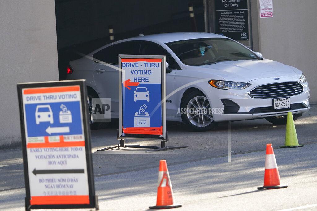 FILE — In this Nov. 3, 2020, file photo a car leaves a drive-thru voting site on Election Day in Houston. As Texas moves ahead with a push to tighten voting laws, Republican lawmakers have zeroed in on Houston and surrounding Harris County. The effort is one of the clearest examples of how the GOP's nationwide campaign to impose new voting restrictions can target Democrats, even as they insist the measures are not partisan. (AP Photo/David J. Phillip, File)