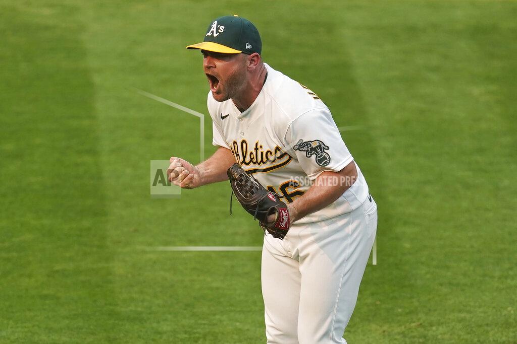 Eric Risberg Oakland Athletics relief pitcher Liam Hendriks celebrates after striking out Chicago White Sox's Nomar Mazara for the final out of Game 3 of an American League wild-card baseball series Thursday, Oct. 1, 2020, in Oakland, Calif. The Athletics won 6-4. (AP Photo/Eric Risberg)