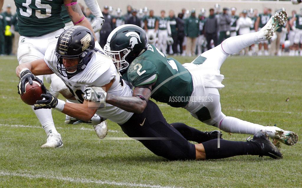 Al Goldis Purdue's Brycen Hopkins, left, dives for the goal line against Michigan State's Justin Layne (2) on a 30-yard pass reception during the third quarter of an NCAA college football game, Saturday, Oct. 27, 2018, in East Lansing, Mich. Hopkins was down short of the goal but Purdue scored on the next play. (AP Photo/Al Goldis)