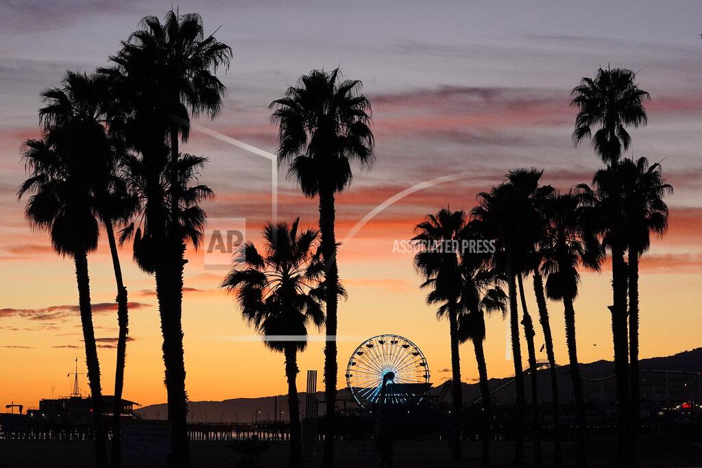 Mark J. Terrill The Ferris wheel on Santa Monica pier is lit up in blue on Santa Monica State Beach, Friday, April 10, 2020, in Santa Monica, Calif. The landmark and several others around Los Angeles and the nation are lit up in blue to show support for medical workers and first responders on the front lines of the coronavirus pandemic. (AP Photo/Mark J. Terrill)