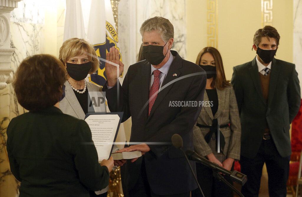 Bob Breidenbach Former Rhode Island Lt. Governor Daniel J. McKee is sworn in as Governor by Secretary of State Nellie Gorbea at the Rhode Island State House, Tuesday, March 2, 2021, in Providence, R.I. Holding the family bible is his wife, Susan McKee, left. McKee was joined by his son, Matthew, daughter, Kara and future daughter-in-law, Laura Clifford. McKee was sworn in as Rhode Island’s 76th governor on Tuesday as former governor Gina Raimondo officially joined President Joe Biden's cabinet as U.S. commerce secretary after winning Senate confirmation. (Bob Breidenbach/Providence Journal via AP, Pool)