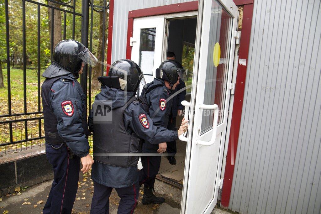Anastasia Yakovleva Police officers enter the Perm State University in Perm, about 1,100 kilometers (700 miles) east of Moscow, Russia, Monday, Sept. 20, 2021. Officials say a gunman has opened fire at a university in Russia, leaving around eight people dead and over 20 injured. The Interior Ministry said the gunman was detained after Monday's shooting at Perm State University. (AP Photo/Anastasia Yakovleva)