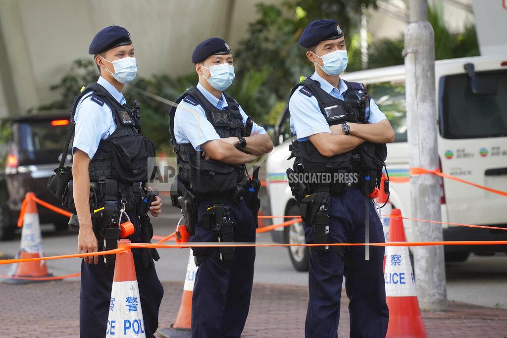 Vincent Yu Police officers stand guard outside local court in Hong Kong Thursday, July 22, 2021. Hong Kong police charged two top editors and two editorial writers at Apple Daily with collusion weeks after the city's largest pro-democracy newspaper was forced to cease publication and its assets were frozen. All four were charged with conspiring to "collude with a foreign country or with external elements to endanger national security" under the city's year-old national security law and appeared in court Thursday. (AP Photo/Vincent Yu)