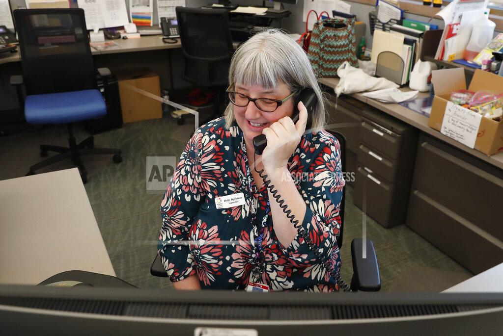 Librarian Holly Ryckman smiles as she chats with 81-year-old Dell Kaplan from the Davis Library in Plano, Texas Friday, May 15, 2020. Ryckman is participating in a program that have popped up across the U.S. during the pandemic to help older adults with a simple offer to engage in small talk. Ryckman said the calls have been "a gift" for her. (AP Photo/LM Otero)